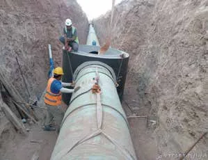 Large-diameter sewer pipe being lowered and jointed in a shored trench in Jeddah Industrial Area 2