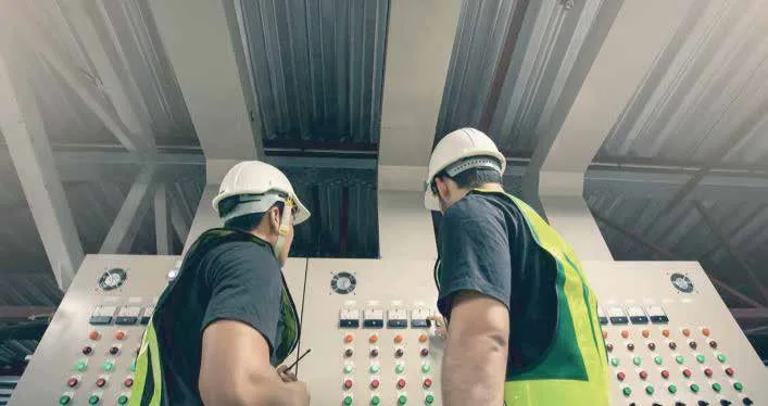NRGC electricians commissioning a control panel on site