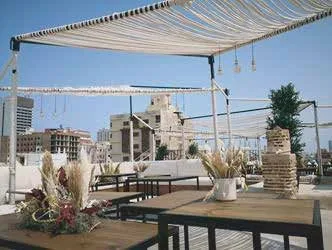 Rooftop terrace with tensile canopy and outdoor furniture